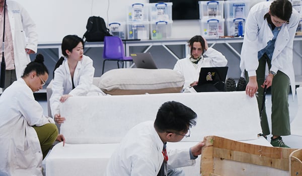 Scientists testing a sofa